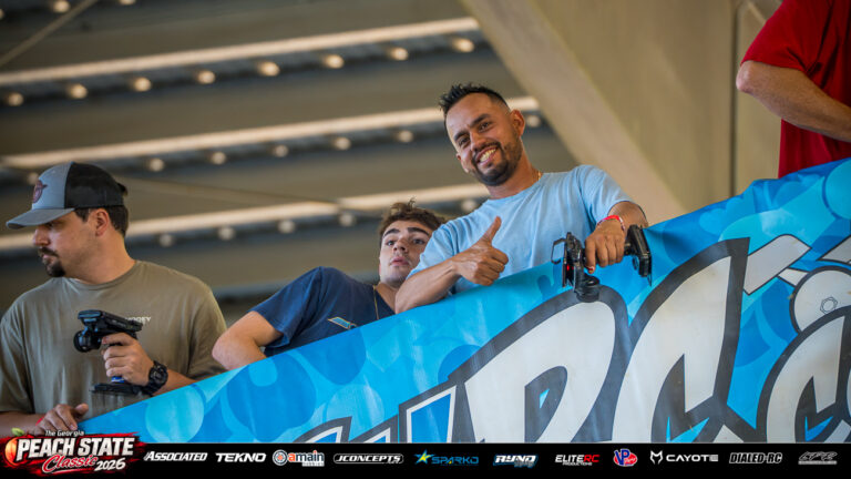 Dario Delgado gives a thumbs-up while holding his radio transmitter on the drivers’ stand at the 2026 Georgia Peach State Classic. A candid moment from the race weekend’s Good Times photo gallery.