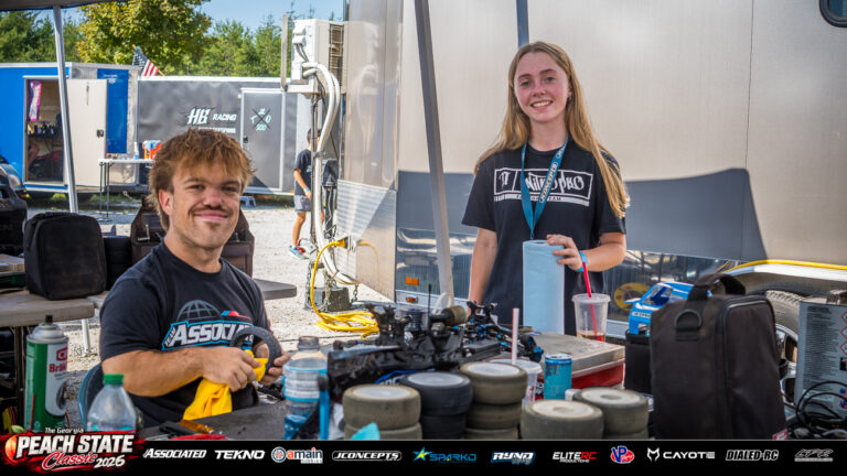Maddy Long and Brandon Rose smile beside a pit table covered with RC tires and a nitro buggy at the 2026 Georgia Peach State Classic. A candid moment from the race weekend’s Good Times photo gallery.