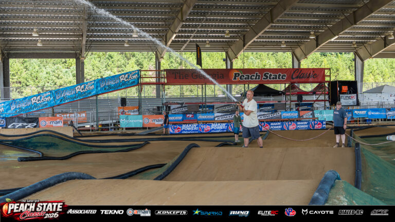 Mark Moon sprays water across the dirt RC track beneath the covered race arena at the 2026 Georgia Peach State Classic. A candid moment from the race weekend’s Good Times photo gallery.