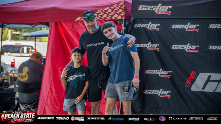Max Mejia and Paxton Helfer pose with a fellow attendee beside the paddock tents at the 2026 Georgia Peach State Classic. A candid moment from the race weekend’s Good Times photo gallery.