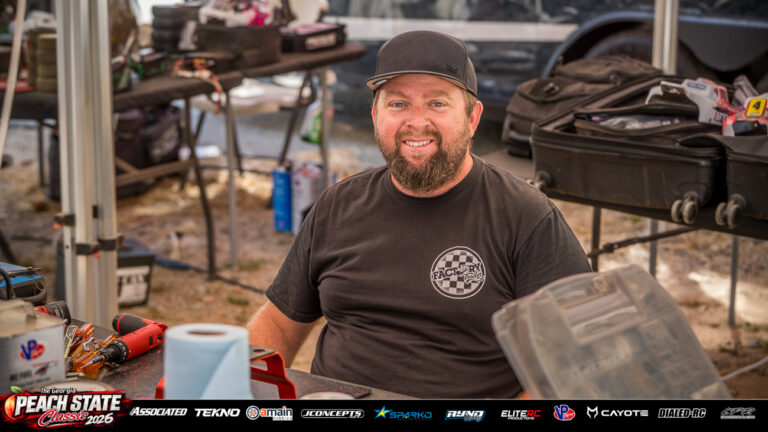 Ryan Maifield smiles at his pit table surrounded by tools and RC racing equipment at the 2026 Georgia Peach State Classic. A candid moment from the race weekend’s Good Times photo gallery.