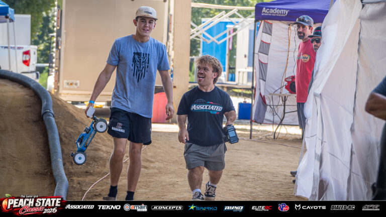 Tyler Melton and Brandon Rose walk beside the track with RC racing equipment and share a laugh at the 2026 Georgia Peach State Classic. A candid moment from the race weekend’s Good Times photo gallery.