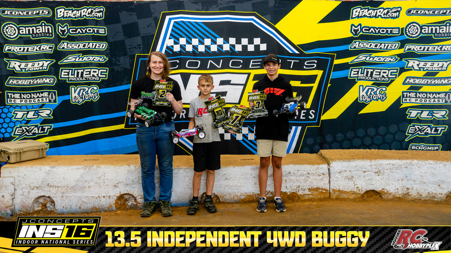 13.5 Independent 4WD Buggy round winners holding RC vehicles and podium awards at the 2026 JConcepts INS16 Finals at Hoosier RC Hobbyplex.