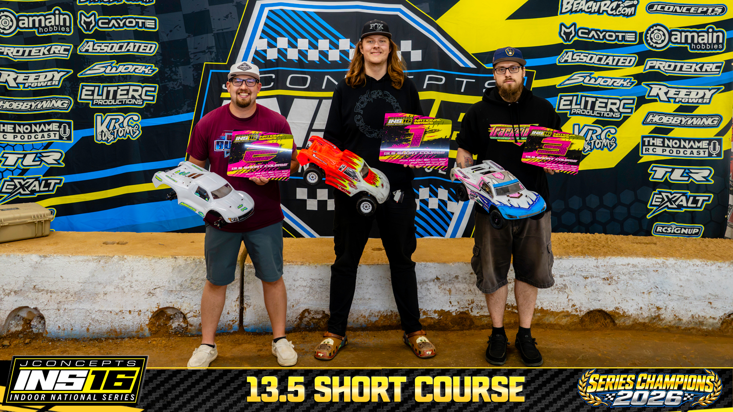 13.5 Short Course INS16 2026 Champions holding RC vehicles and series awards.