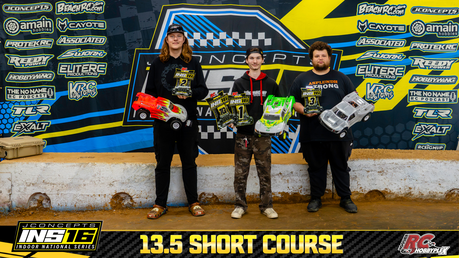 13.5 Short Course round winners holding RC vehicles and podium awards at the 2026 JConcepts INS16 Finals at Hoosier RC Hobbyplex.