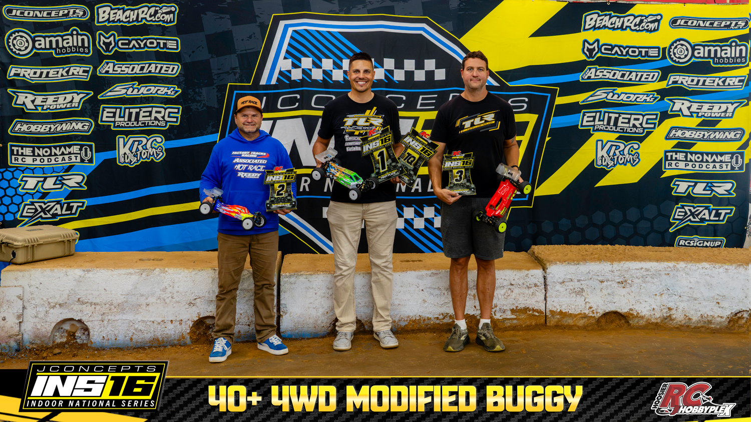 40+ 4WD Modified Buggy round winners holding RC vehicles and podium awards at the 2026 JConcepts INS16 Finals at Hoosier RC Hobbyplex.