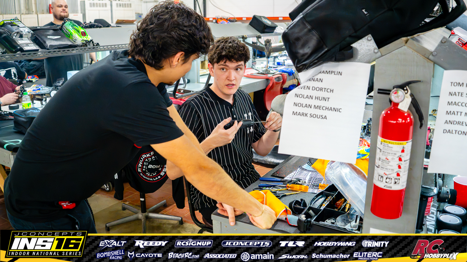 Broc Champlin discussing race preparation in the pits at the 2026 JConcepts INS Finals at Hoosier RC Hobbyplex